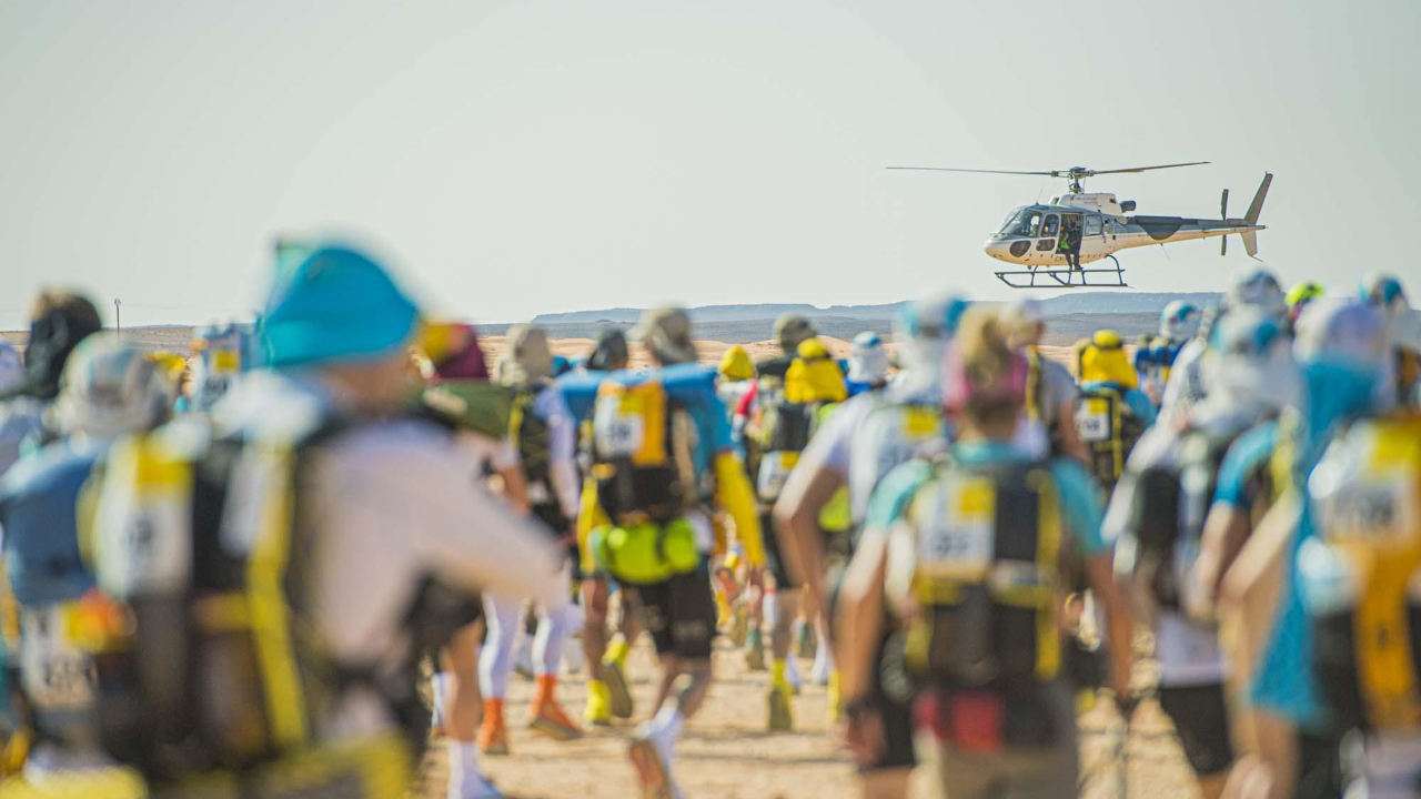 A helicopter above runners at the 2021 Marathon des Sables