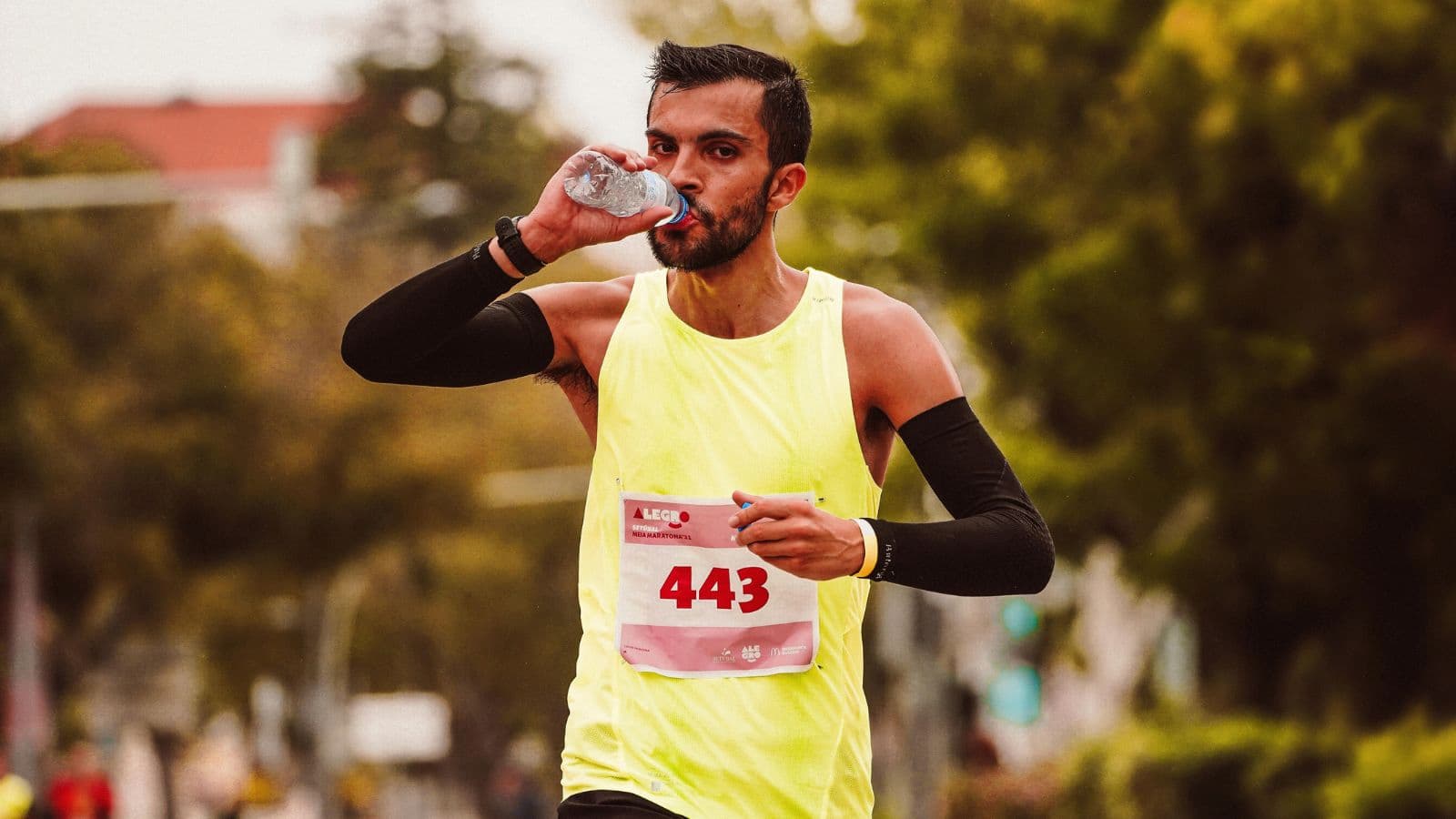 Runner drinking electrolytes before run to improve hydration and support pre-run energy levels