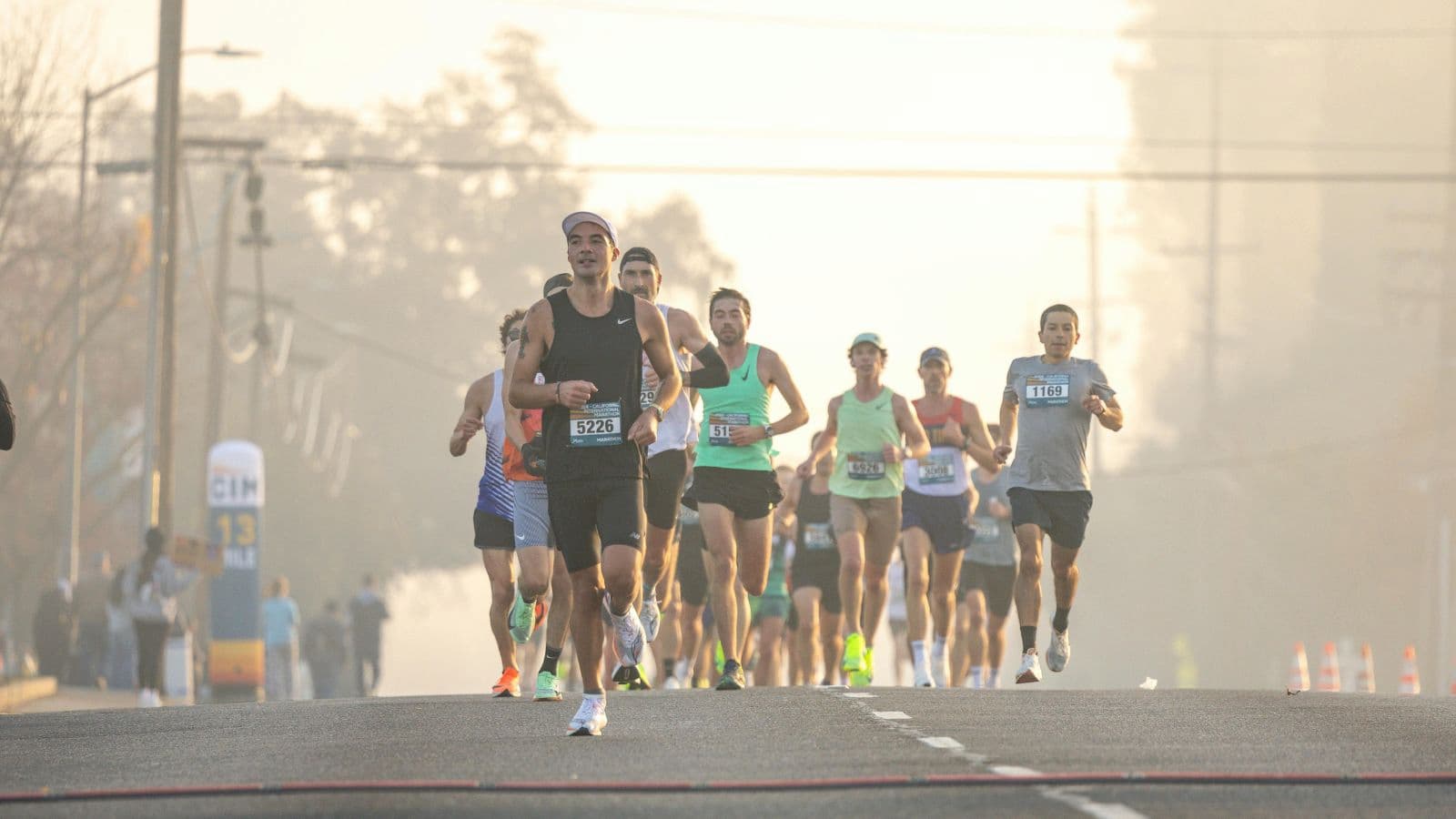 Runners maintaining proper form during race, showing upright posture and efficient stride