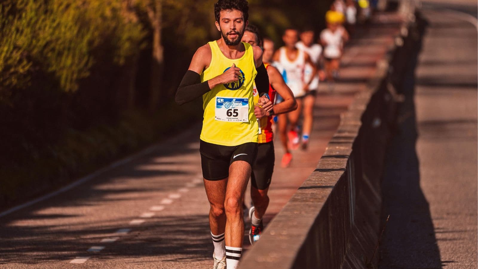 Group of runners racing with consistent cadence and relaxed upper body movement