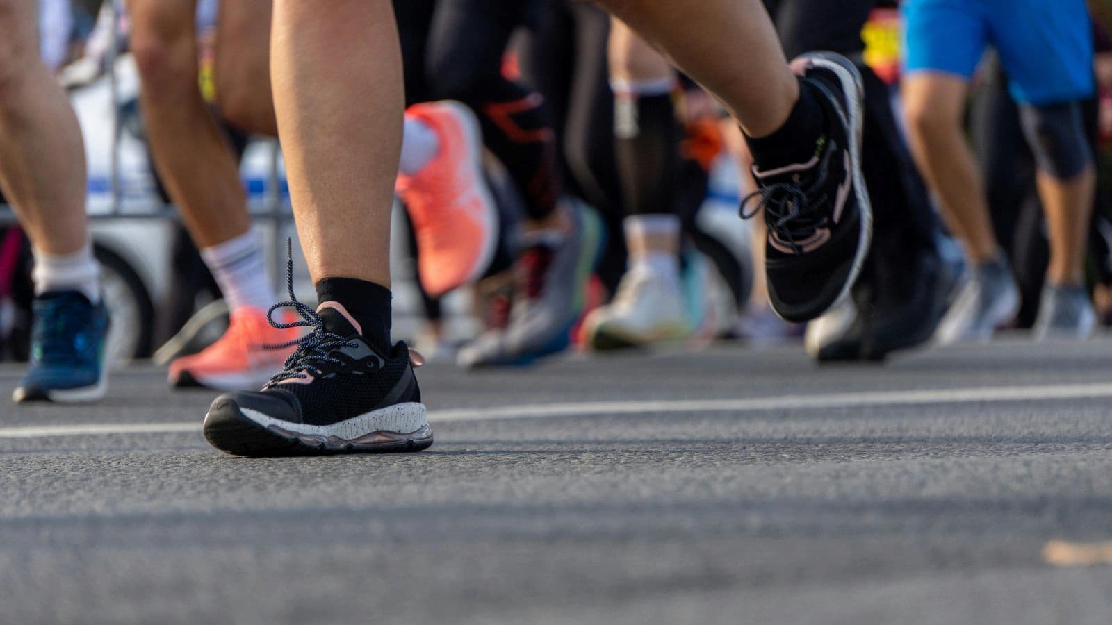 Runner’s feet in motion showing efficient stride and cadence during training run