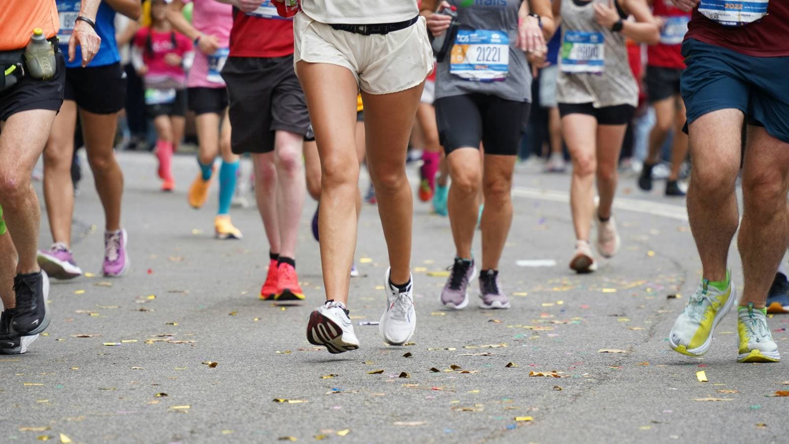 Group of marathon runners maintaining steady cadence to improve performance and reduce injury risk