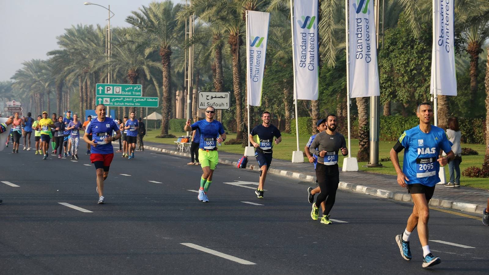 Group of runners racing on a road course, demonstrating stamina, pacing, and long-distance running endurance