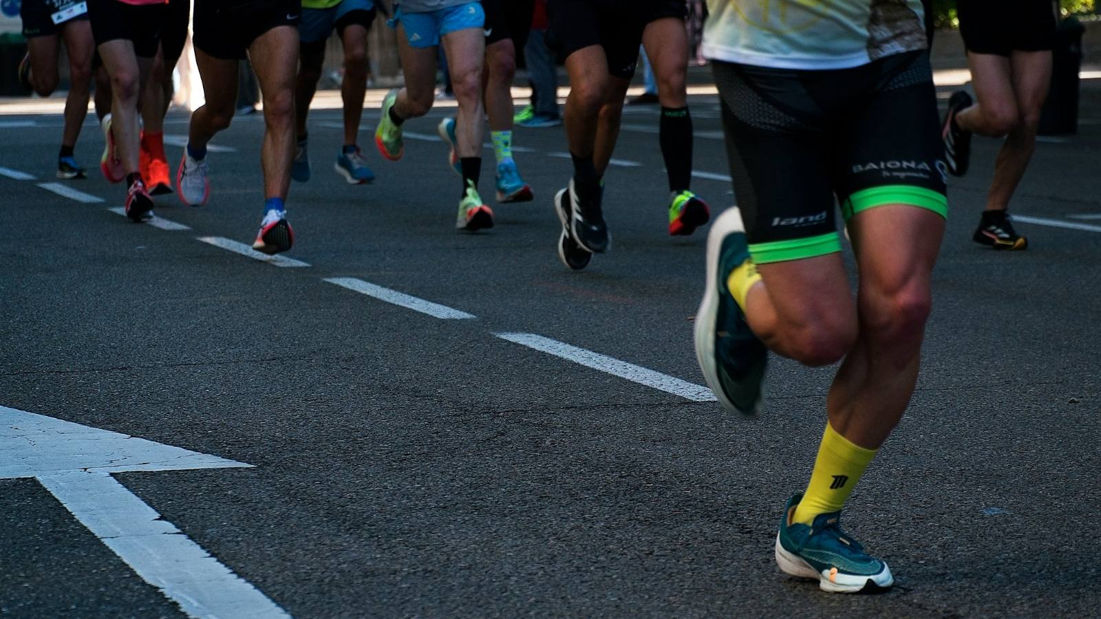 Long-distance runner pacing steadily during a marathon to conserve energy and finish strong