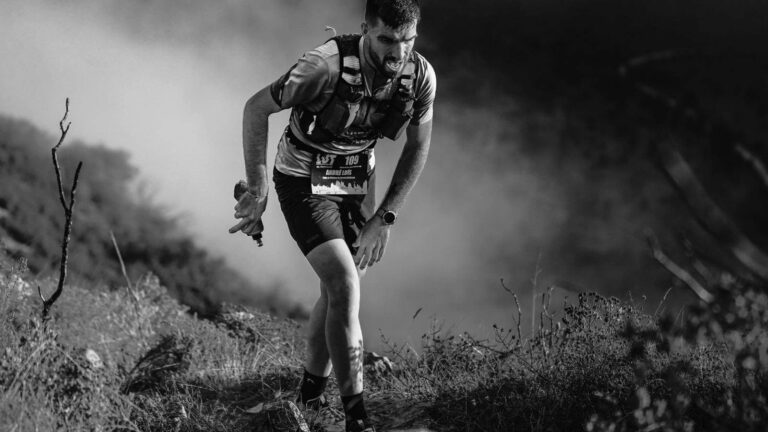 Single runner racing in an ultramarathon on a long-distance course, representing endurance training, pacing strategy, and the role of speed work in ultramarathon preparation.