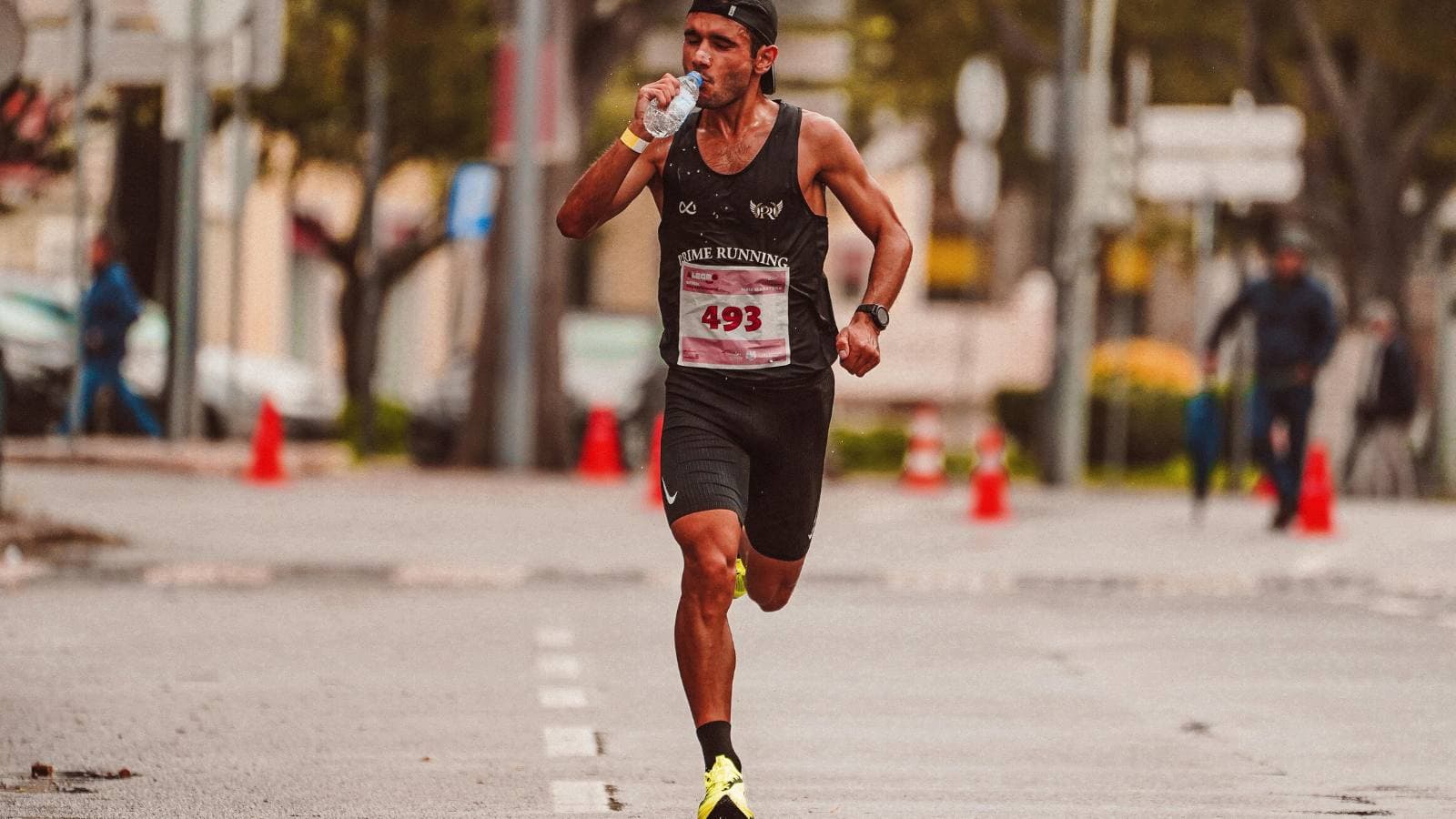 ultramarathon runner consuming energy gels and hydration during long distance trail race