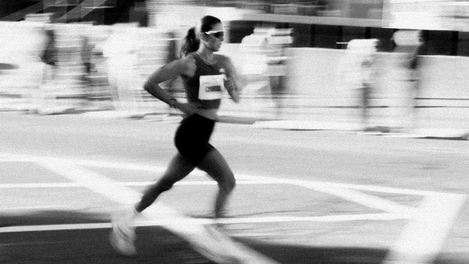 runner reviewing marathon training schedule with weekly runs and mileage progression