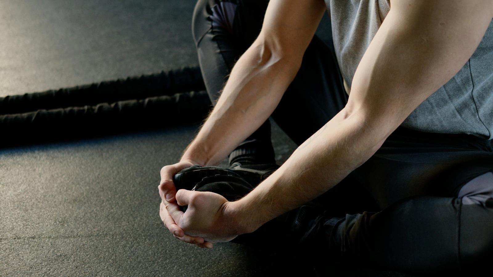 athlete doing hip and ankle mobility exercises before running workout