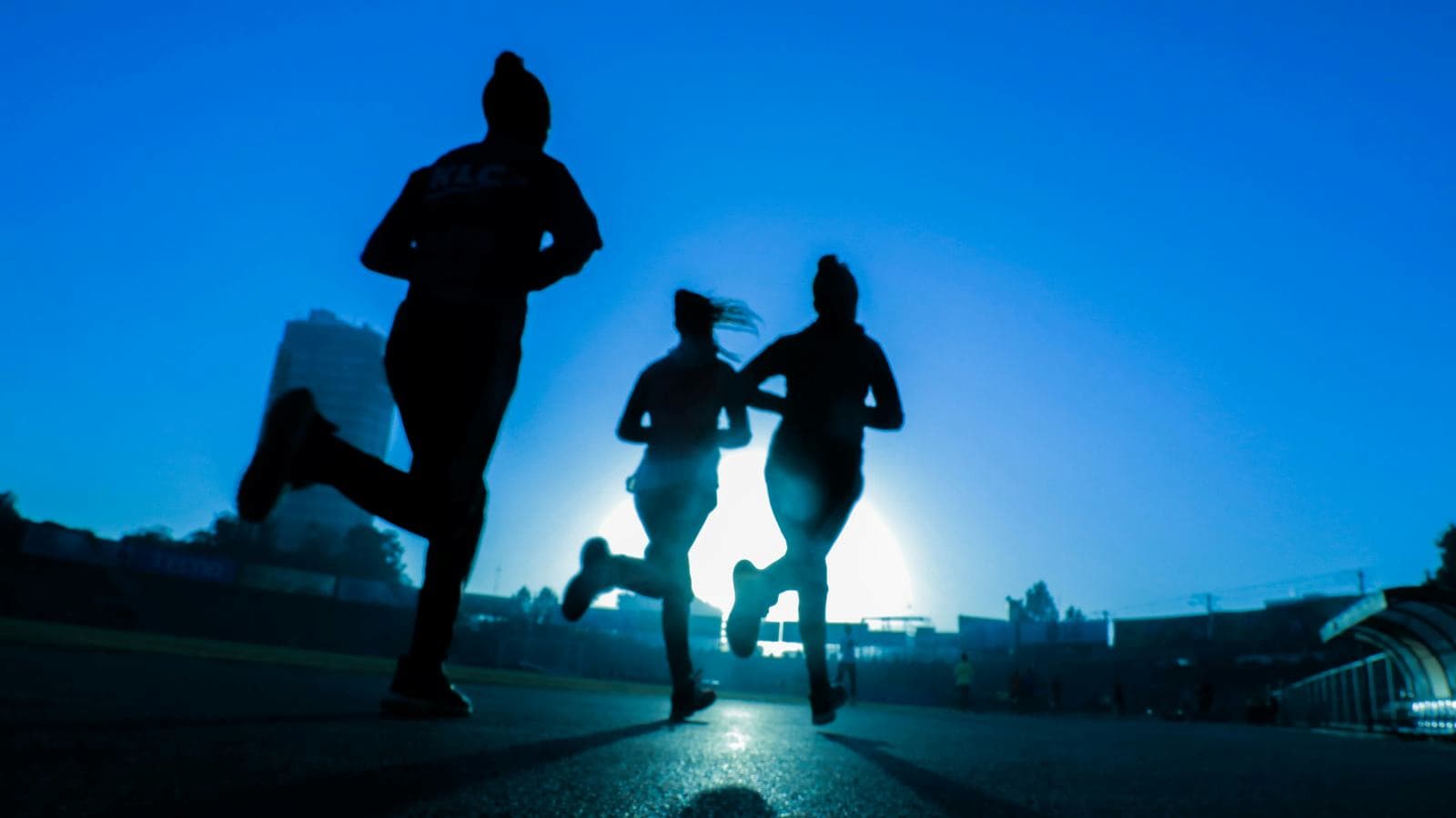 distance runner maintaining steady pace during marathon training session focused on long term progress