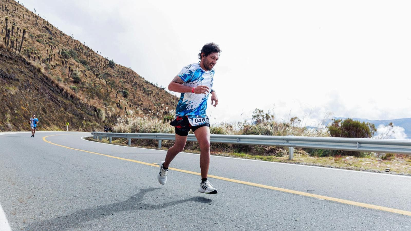 distance runner jogging on mountain trail during altitude training session