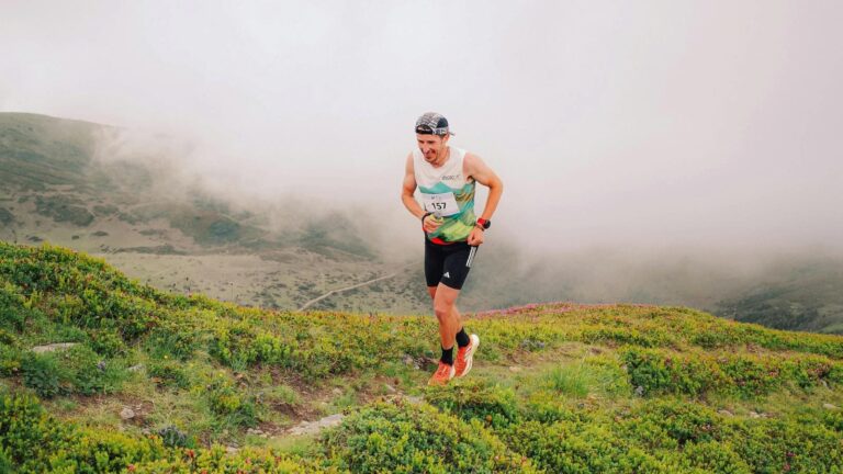 athlete running in mountainous environment to build endurance and altitude adaptation