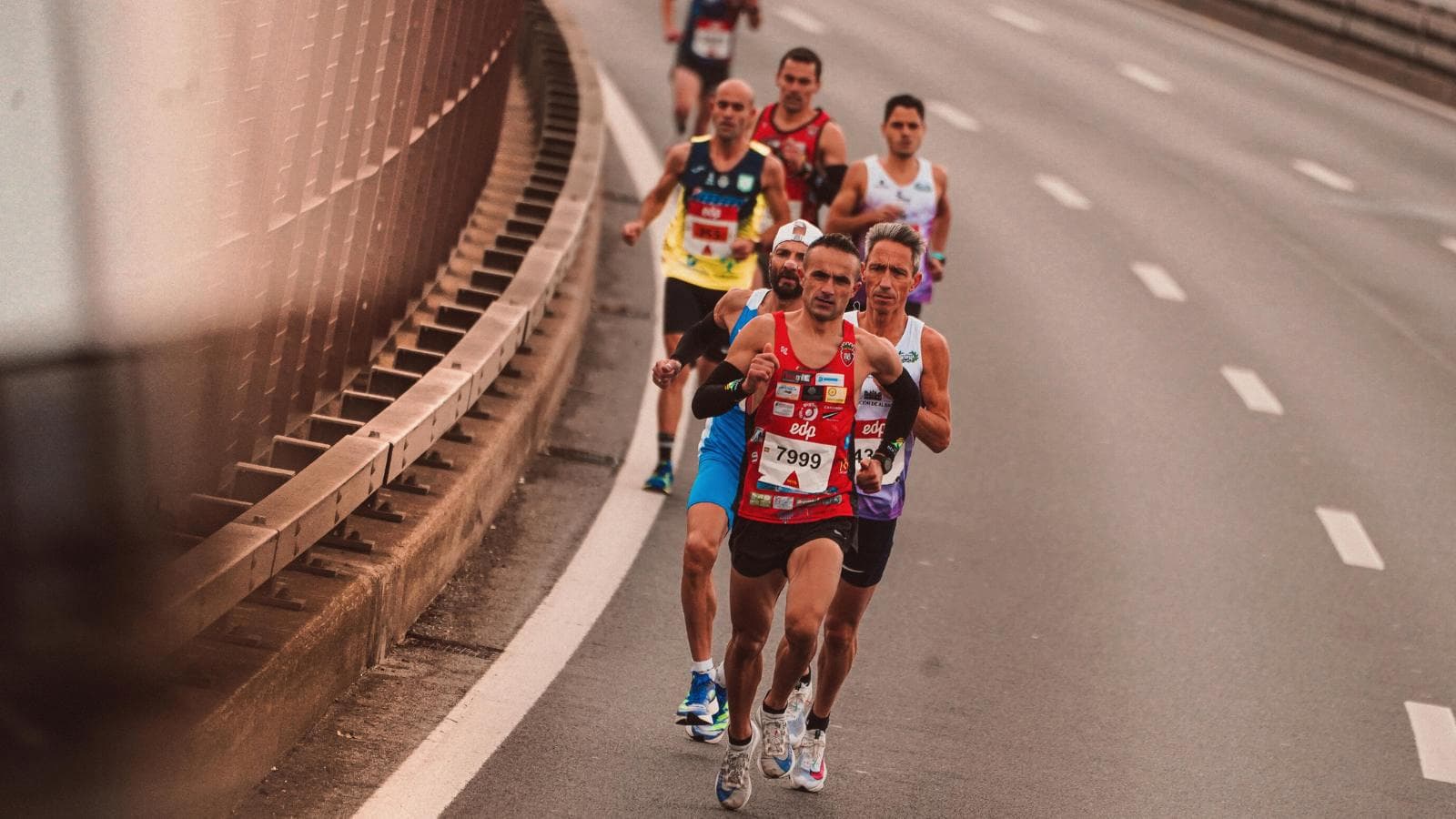 distance runner descending hill with controlled stride and balanced running form during marathon