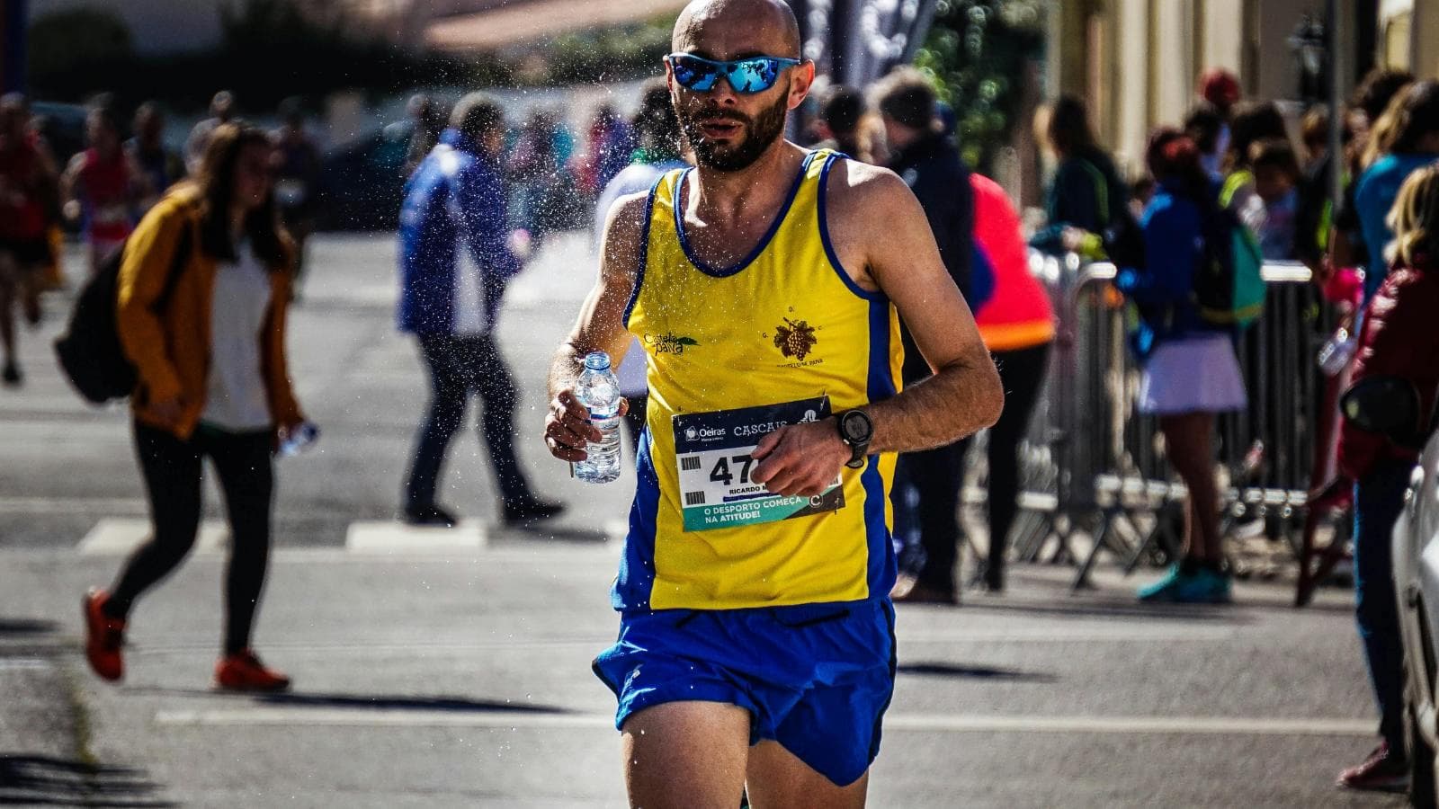marathon runner drinking water during race to prevent dehydration and maintain endurance