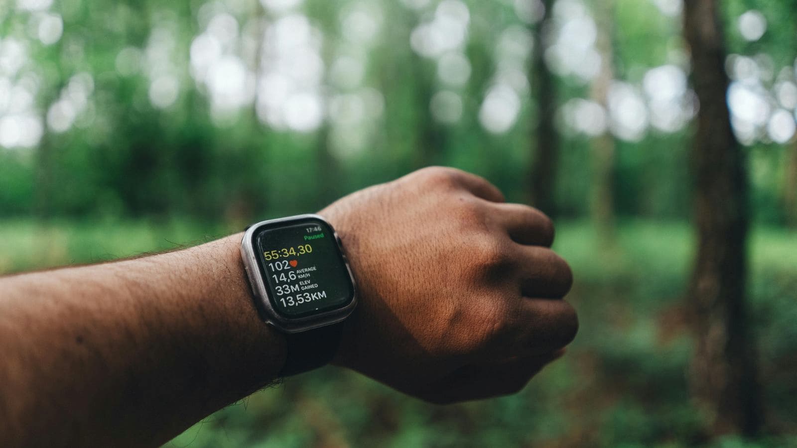 fatigued runner monitoring smartwatch heart rate data during low intensity run