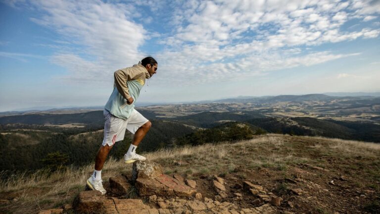 runner climbing steep hill during workout to increase endurance and lower body strength