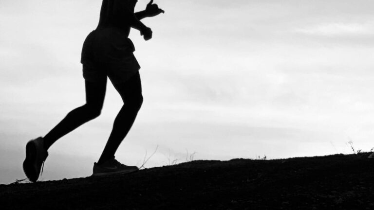 trail runner completing uphill interval training to improve trail race performance and leg strength