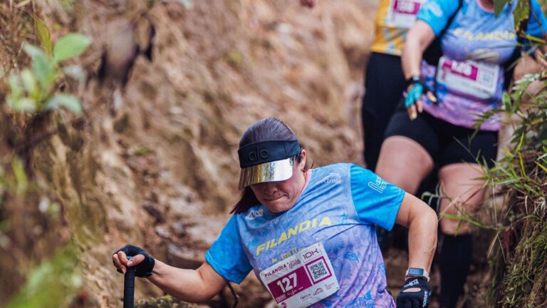 trail runner completing uphill intervals to improve speed and fitness for a trail 10K race