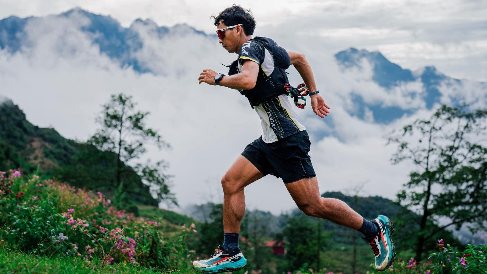trail runner performing uphill and downhill interval training on mountain trail to improve race performance