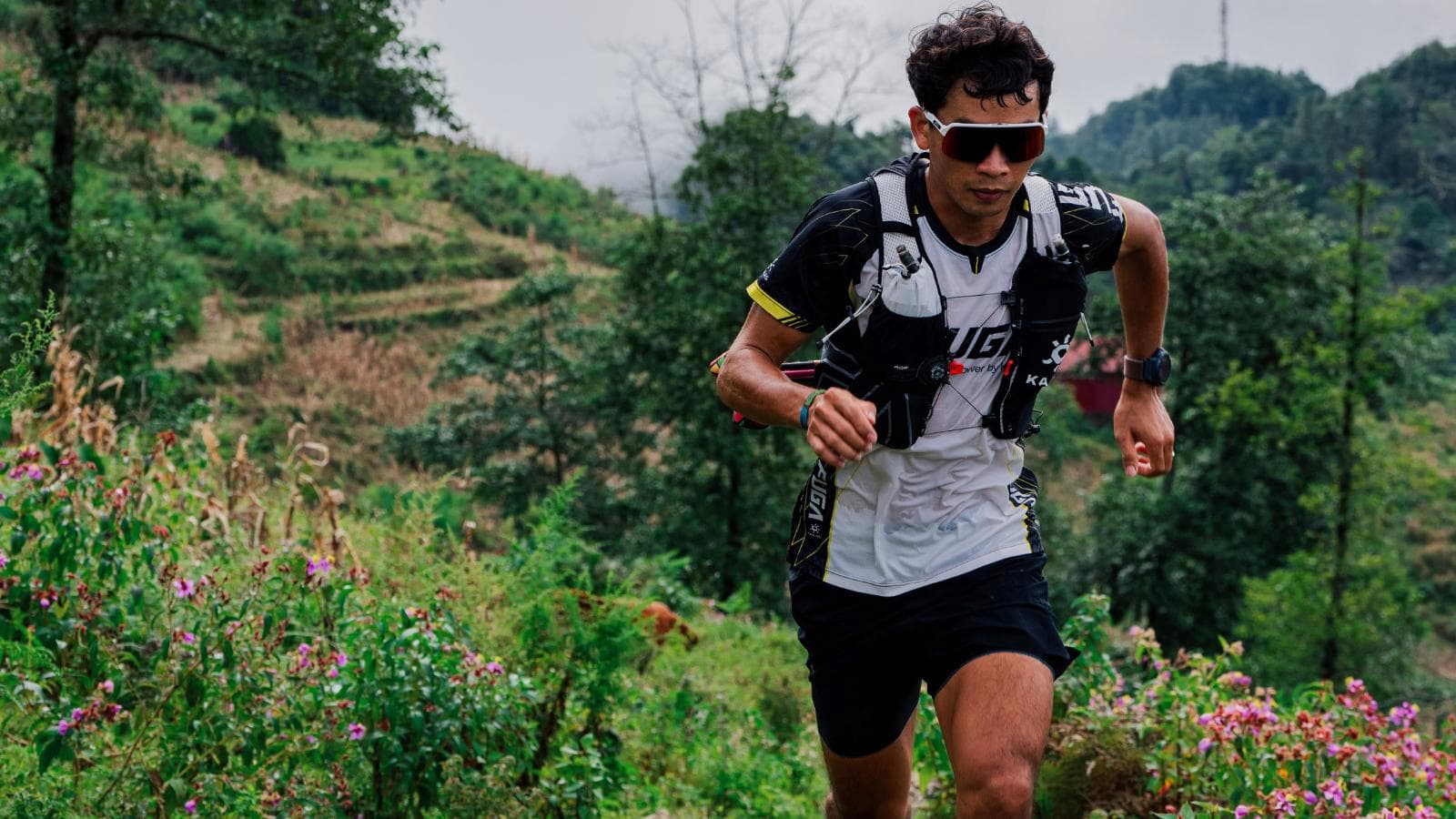 trail runner cooling down after run with light walking and stretching on mountain trail