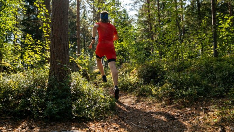 new trail runner wearing proper gear and running shoes on beginner friendly outdoor trail