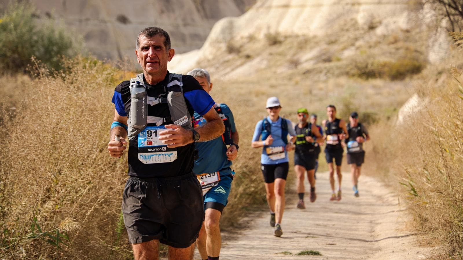 road runner and trail runner training on different terrains highlighting differences in marathon and trail running preparation