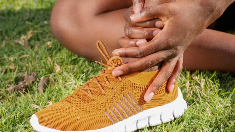 trail runner navigating rocky trail where uneven ground increases ankle sprain risk