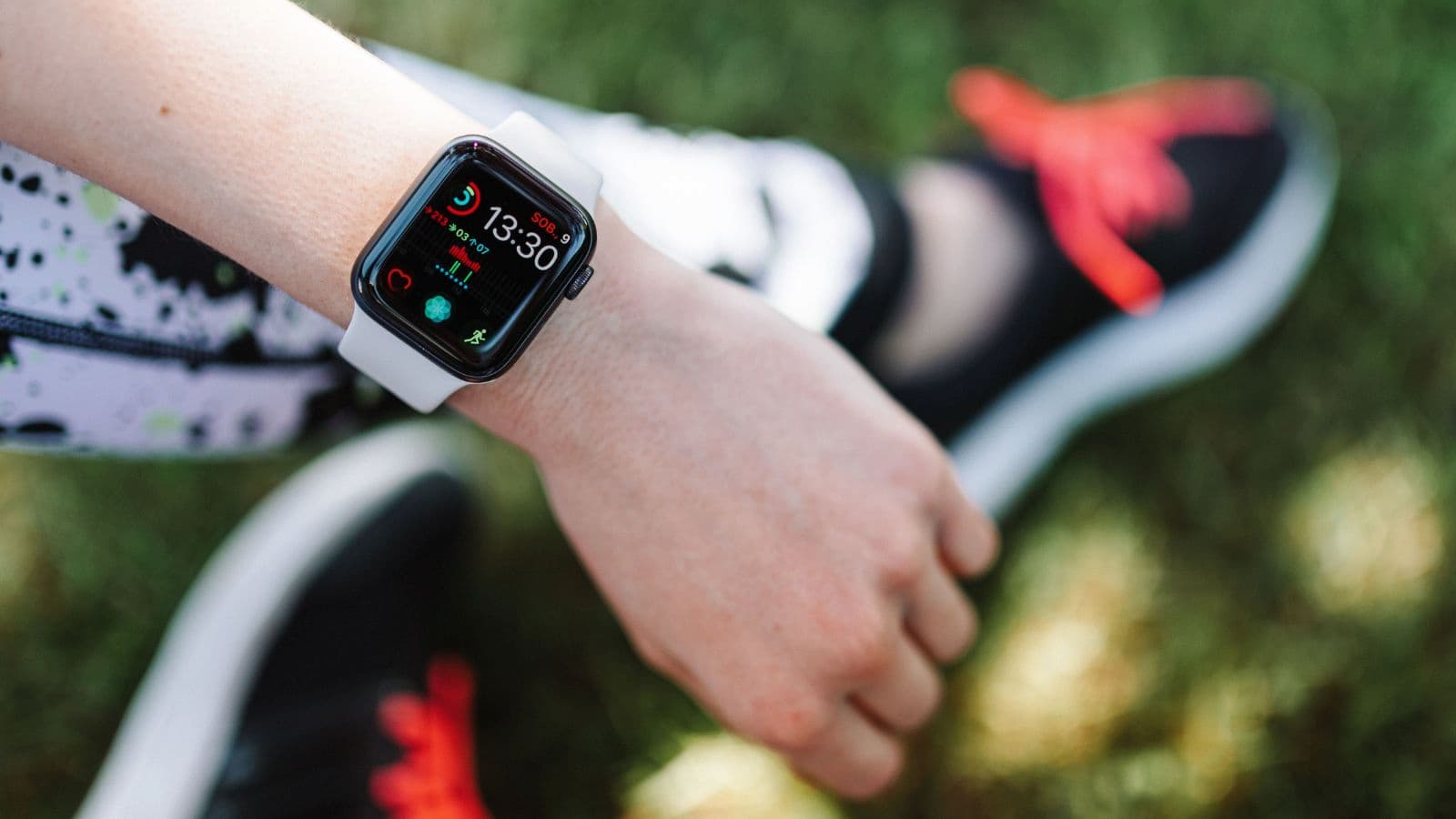 trail runner using GPS watch and wearable technology during mountain trail running workout