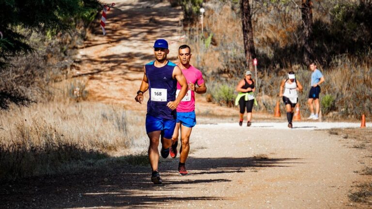 Long-distance runner maintaining a relaxed and controlled pace during the early stages of an endurance race.