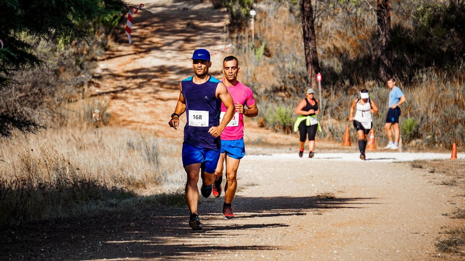 Long-distance runner maintaining a relaxed and controlled pace during the early stages of an endurance race.