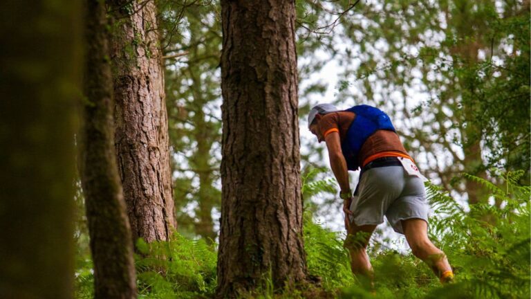 trail runner experiencing chest pain while running on mountain trail and stopping to assess symptoms