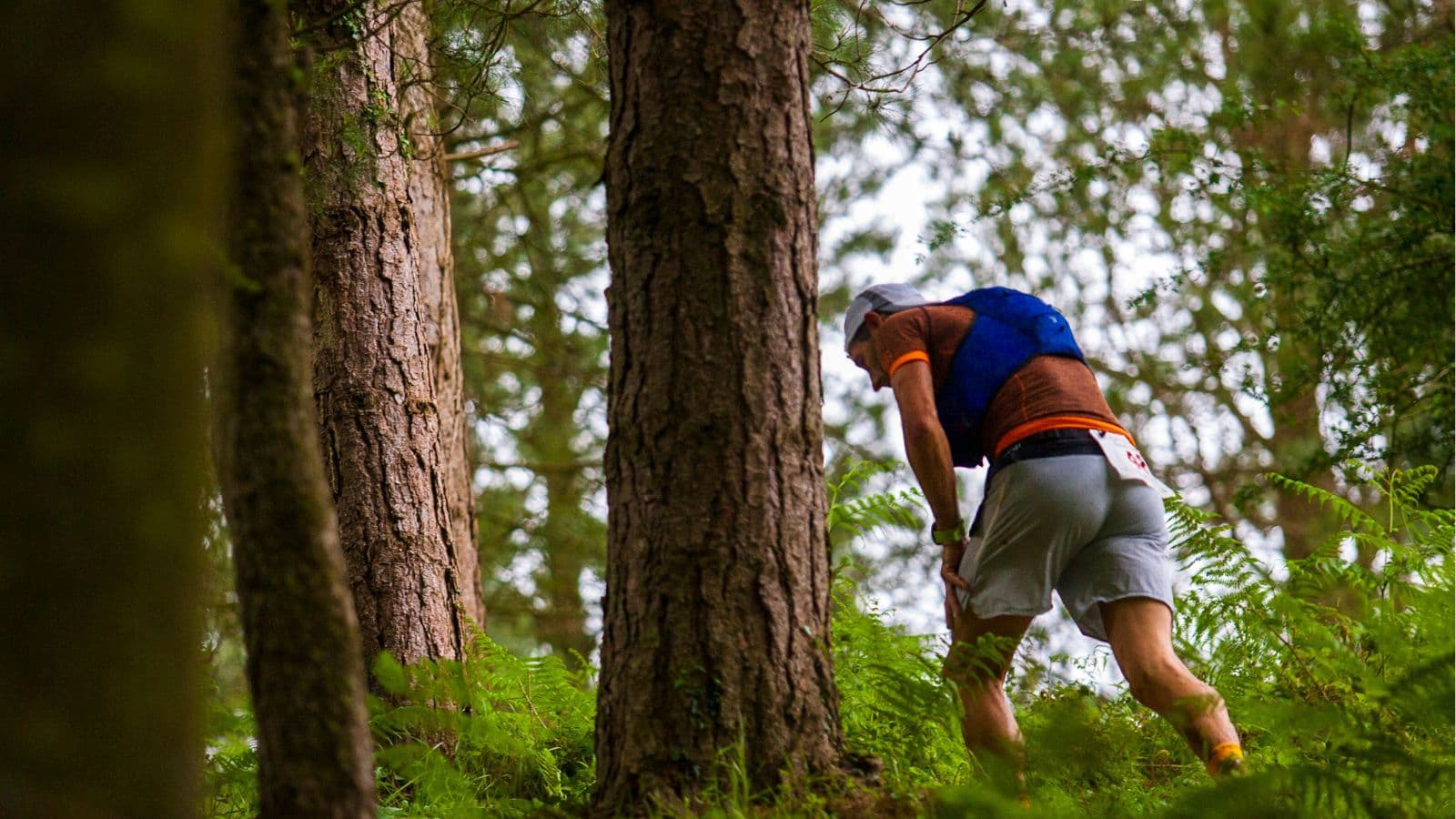 trail runner experiencing chest pain while running on mountain trail and stopping to assess symptoms