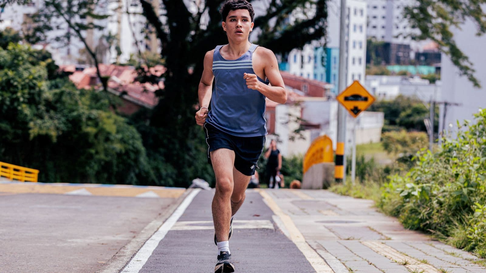 Triathlete running at an easy conversational pace during an aerobic training session to build endurance and improve race performance.