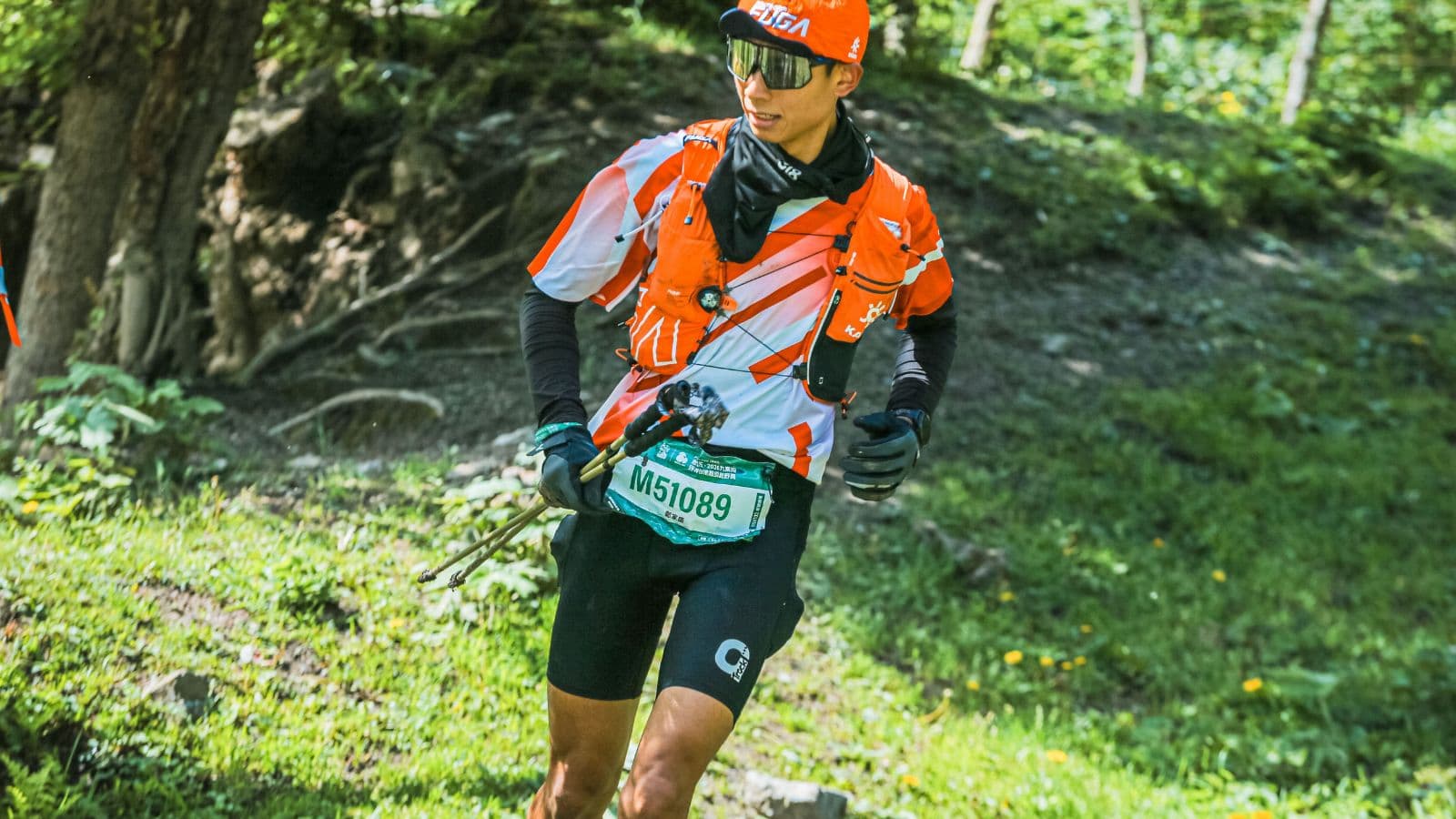 Trail runner maintaining an upright posture with a slight forward lean while running on a forest trail.
