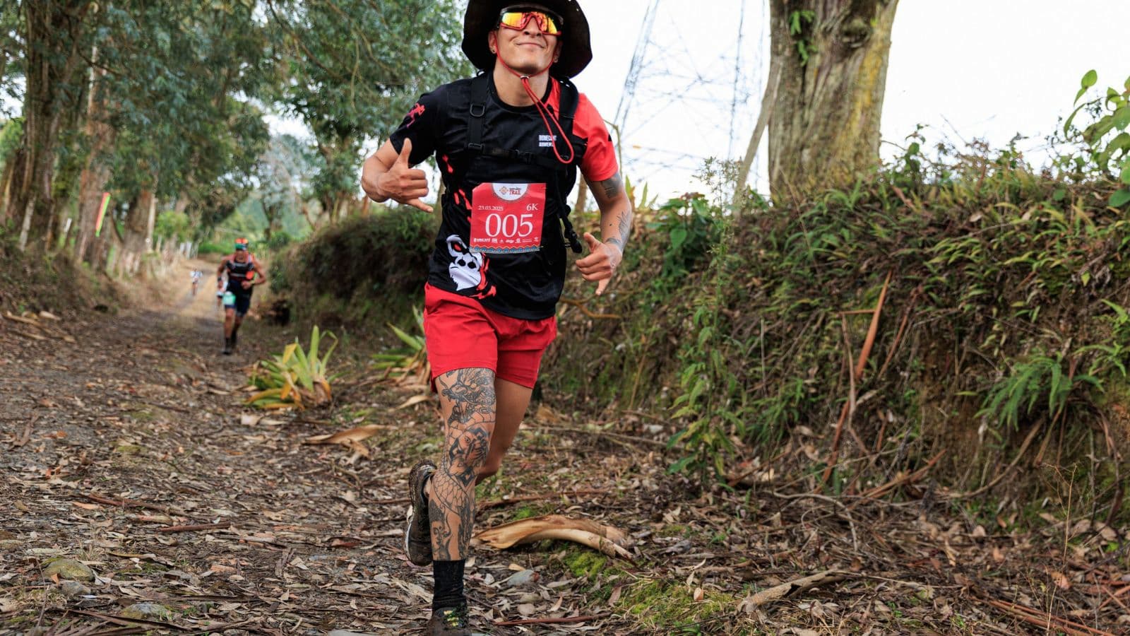 trail runner recovering after run with stretching hydration and nutrition on mountain trail