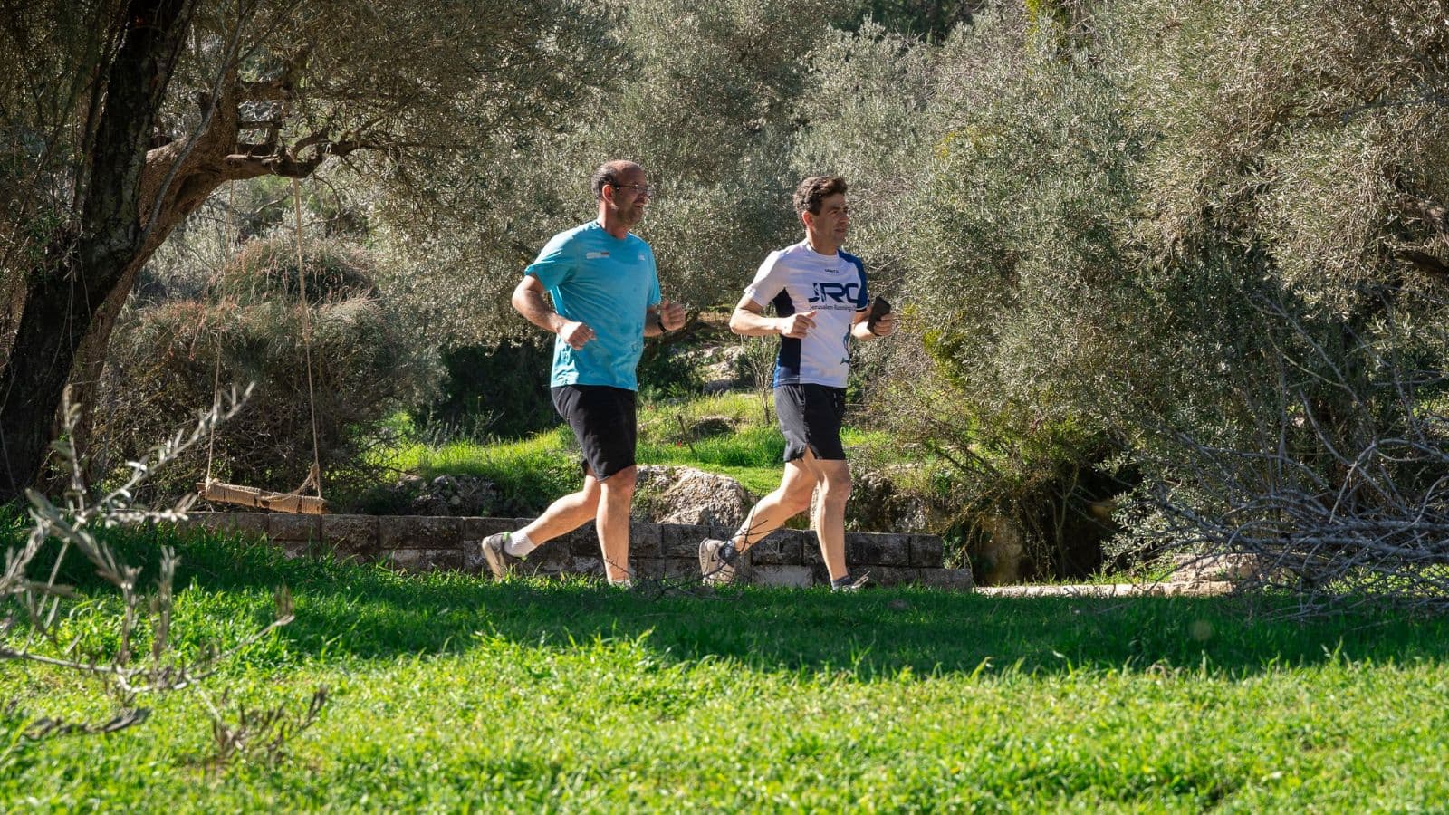 Trail runner completing a long run on scenic trails during the weekend to prepare for upcoming trail races while balancing a busy lifestyle.