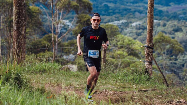 urban trail runner training on city park trails with hills and natural terrain to improve endurance
