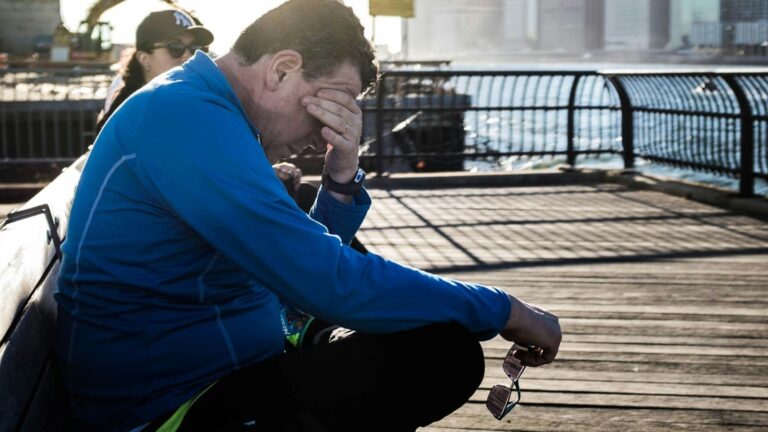 trail runner checking training plan before early morning trail run to manage time effectively