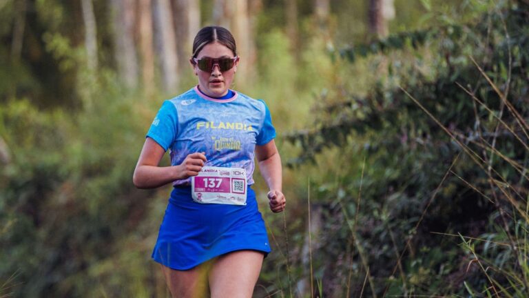 Trail runner alternating between running and walking on rolling trails while returning to training after time off.