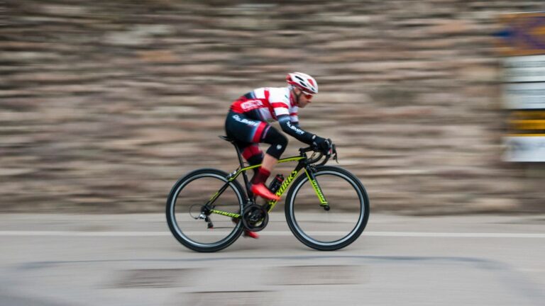 trail runner cycling on mountain road as cross training for better trail running fitness