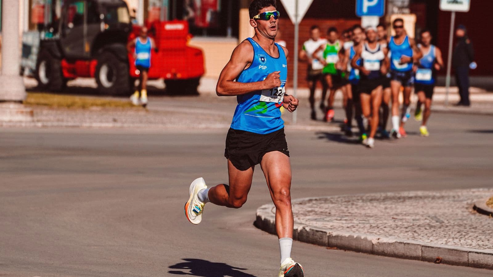 Runner maintaining relaxed bent elbows and a controlled arm swing while running with efficient form.
