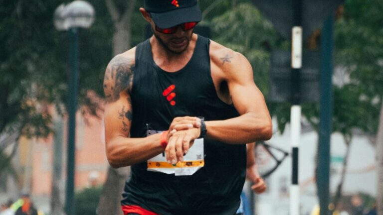 Trail runner navigating a narrow mountain valley surrounded by steep cliffs that can reduce GPS accuracy.