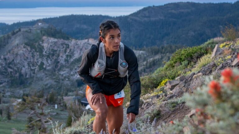 Exhausted trail runner stopping to rest after experiencing unusually severe fatigue during a long trail run.