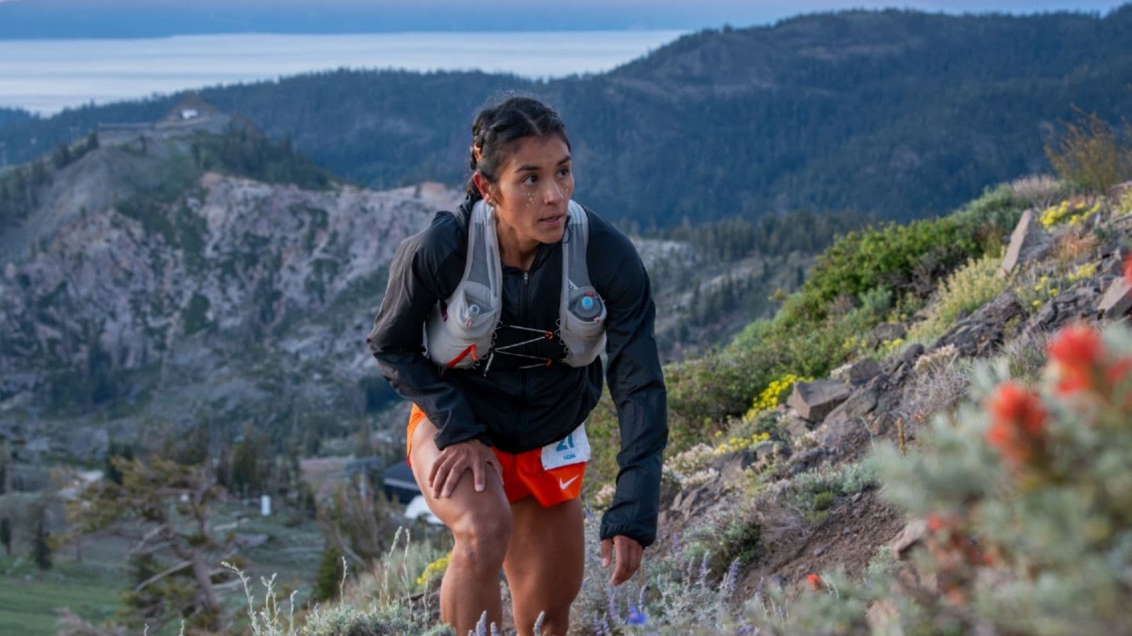 Exhausted trail runner stopping to rest after experiencing unusually severe fatigue during a long trail run.