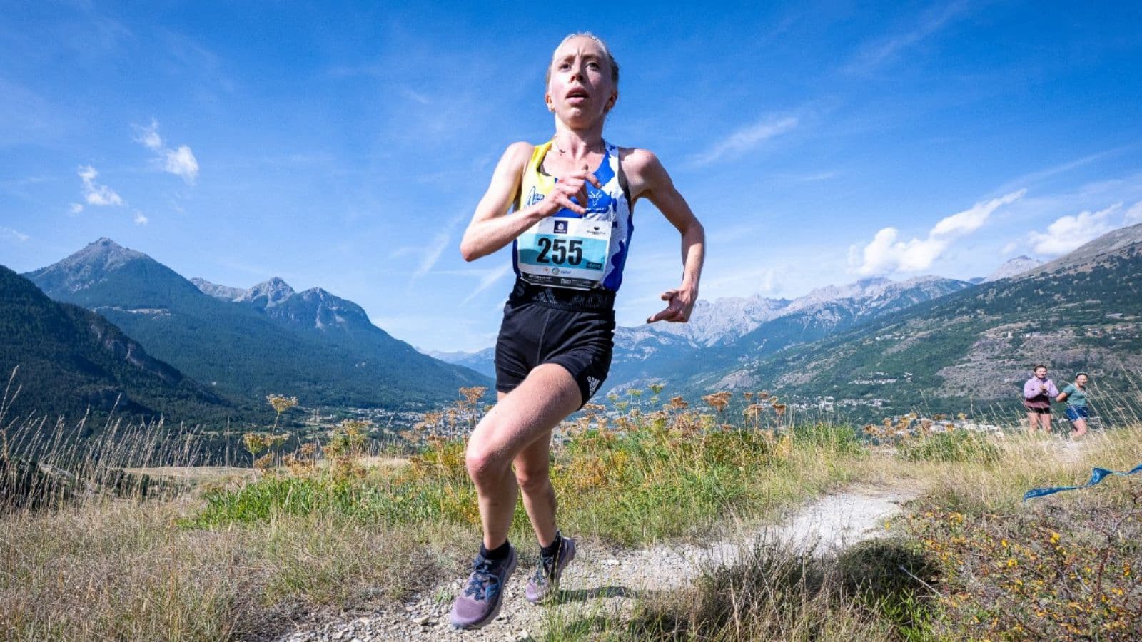 Trail runner looking mentally fatigued while continuing through the difficult later stages of a long-distance run.