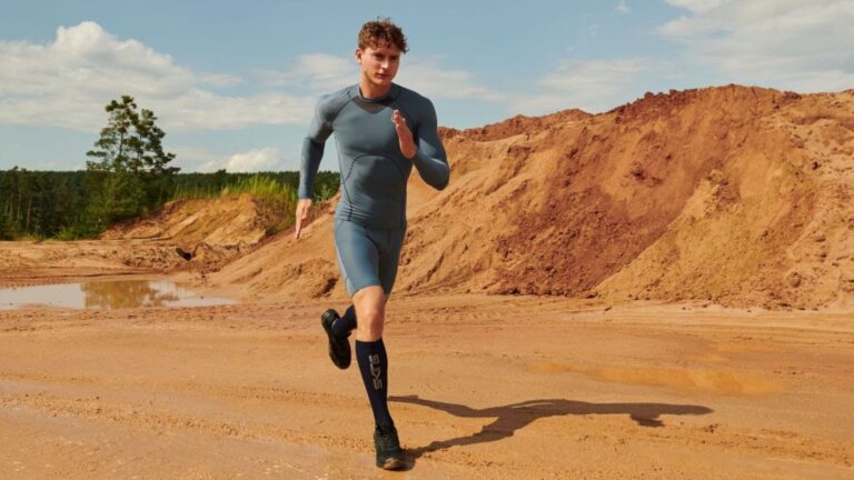 Distance runner maintaining a faster pace at a controlled effort during a regular training run.