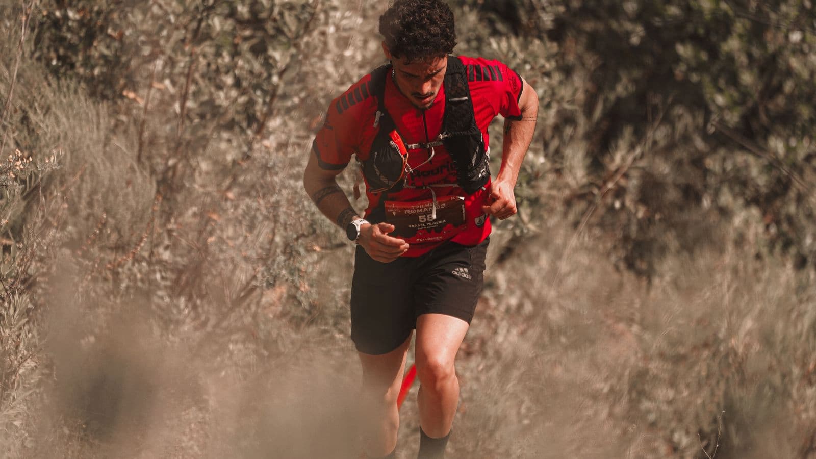 Trail runner using a GPS watch and smartphone mapping app to navigate safely after getting lost on a trail.