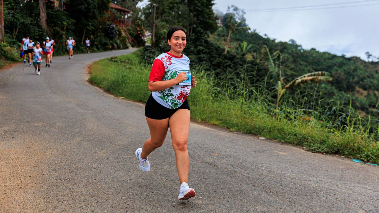 Trail runner descending a steep technical trail with controlled posture and quick, balanced steps.