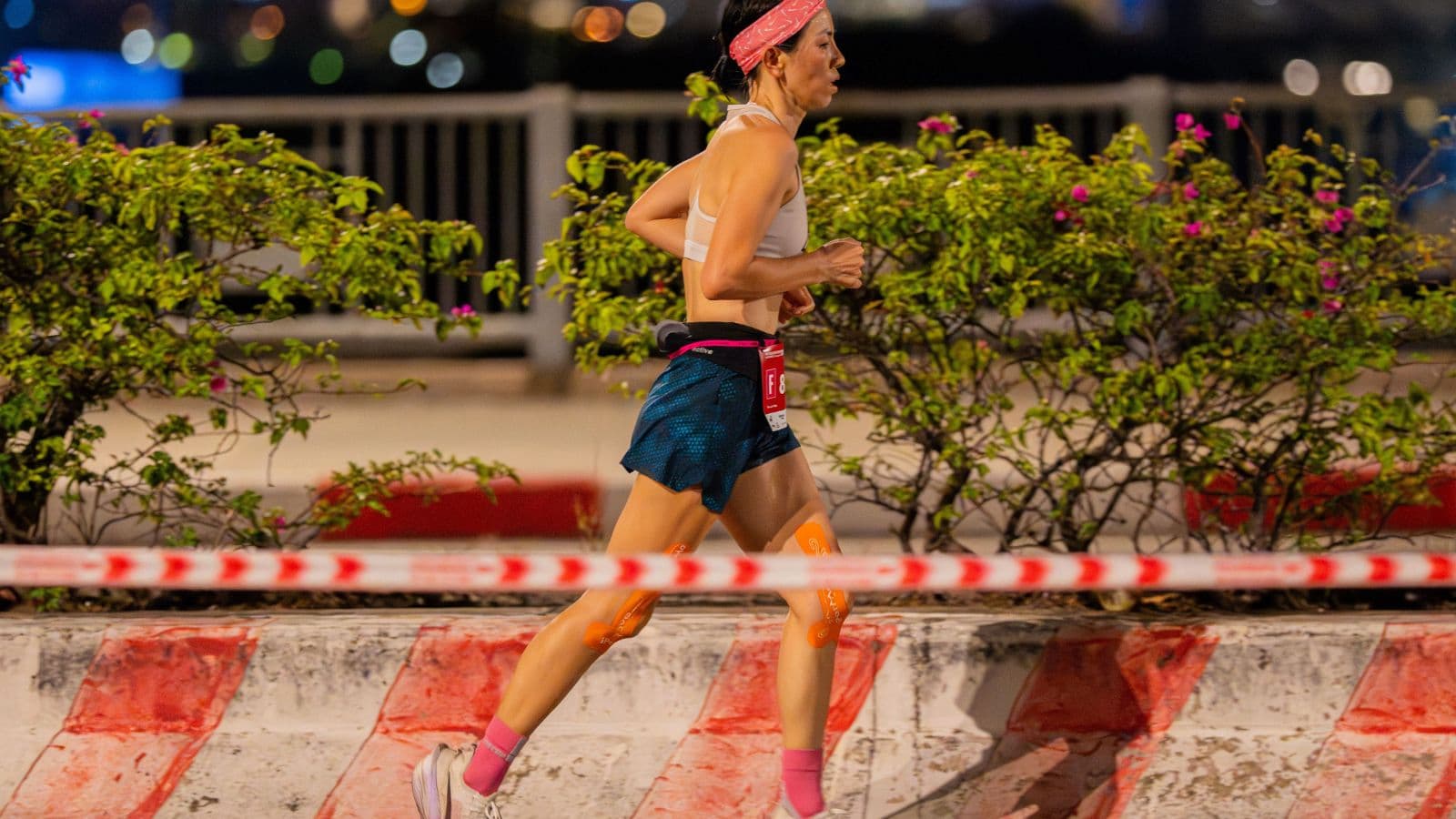 Trail runner completing a relaxed evening run several hours after finishing an earlier training session.