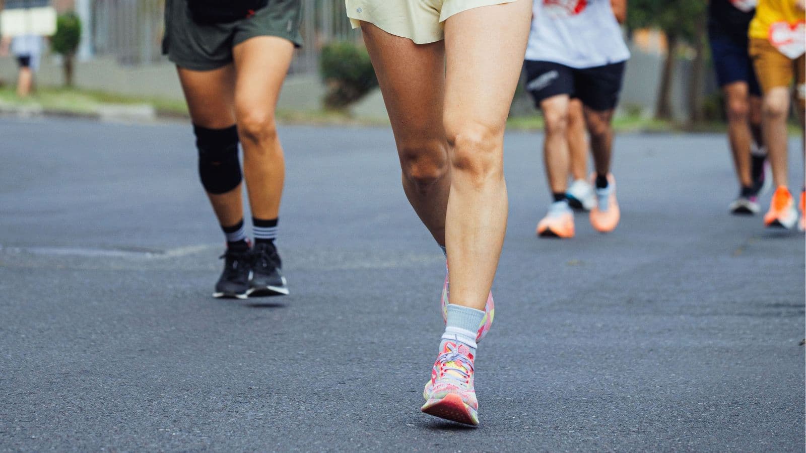 Two runners demonstrating different natural foot and ankle movement patterns while running at an easy pace.