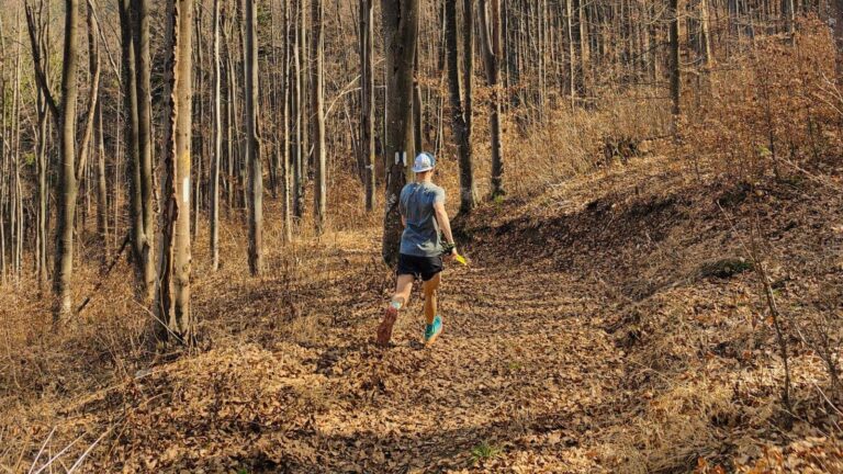 Trail runner sharing route details and expected return time with a family member before heading out alone.